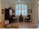Cozy den with modern furniture, wood look floors, and a tranquil window with plantation shutters at 3962 Kennebunk Loop, Mount Dora, FL 32757