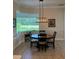 Charming dining area featuring a modern chandelier and a large window with green view at 3962 Kennebunk Loop, Mount Dora, FL 32757