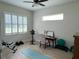 Bright exercise room with weights, exercise bike, mat and bright windows at 3962 Kennebunk Loop, Mount Dora, FL 32757