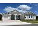Charming home with stone accents, blue shutters, well-manicured lawn, and stylish architectural details at 3962 Kennebunk Loop, Mount Dora, FL 32757