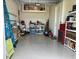 Well-organized garage with epoxy floors, storage shelves, and ample space for vehicles at 3962 Kennebunk Loop, Mount Dora, FL 32757