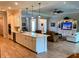 Open kitchen and living area features sleek countertops, stainless appliances and tiled floors at 3962 Kennebunk Loop, Mount Dora, FL 32757
