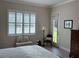 Bright bedroom with white plantation shutters, accent chair, and direct access to the outdoor space at 3962 Kennebunk Loop, Mount Dora, FL 32757