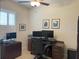 Functional office space with a dark wood desk, multiple monitors, and a comfortable chair at 3962 Kennebunk Loop, Mount Dora, FL 32757