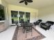 Relaxing covered patio with comfortable seating, a ceiling fan, and large sliding glass doors at 3962 Kennebunk Loop, Mount Dora, FL 32757