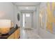 Inviting hallway with neutral paint, ceramic tile floors, and decoratively adorned console table at 12365 Sw 54Th Lane Rd, Ocala, FL 34481