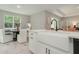 Charming kitchen with white cabinetry, modern sink, and stainless steel appliances and large window at 12365 Sw 54Th Lane Rd, Ocala, FL 34481