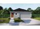Charming single-story home featuring a gray exterior, attached two-car garage, and well-manicured landscaping at 2747 San Marco Way, Winter Haven, FL 33884