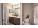 Well-lit bathroom with double vanity, neutral cabinets, and decorative accents at 2755 San Marco Way, Winter Haven, FL 33884