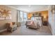 Comfortable bedroom with large window, warm wall color, neutral bedding, and seating area at 2755 San Marco Way, Winter Haven, FL 33884