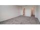 Bright bedroom with grey carpet and spacious closet at 1445 General Mac Arthur Ave, Daytona Beach, FL 32114