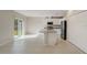 Open kitchen with granite island and stainless steel appliances at 1445 General Mac Arthur Ave, Daytona Beach, FL 32114