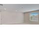 Bright and airy living room with large window and tile flooring at 1445 General Mac Arthur Ave, Daytona Beach, FL 32114