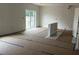 Large unfinished living room with a sliding glass door to the outside and covered flooring at 1445 General Mac Arthur Ave, Daytona Beach, FL 32114