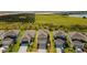 Eye-level aerial view of new construction homes surrounded by lush lawns and verdant landscapes at 7367 Catania Loop, Clermont, FL 34714