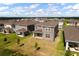 Backyard view shows a well-maintained lawn, patio, and the rear elevation of the home at 7367 Catania Loop, Clermont, FL 34714