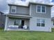 Covered patio with seating area, sliding glass doors, and grassy backyard at 7367 Catania Loop, Clermont, FL 34714