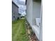 Landscaped backyard with green lawn and a small patio area, providing a serene outdoor space at 7367 Catania Loop, Clermont, FL 34714