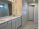 Bathroom features a double sink vanity with modern fixtures and a glass shower at 7367 Catania Loop, Clermont, FL 34714