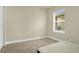 Simple bedroom with carpeted floors and a window with blinds at 7367 Catania Loop, Clermont, FL 34714