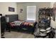 The bedroom is furnished with a dark bed set and is decorated with gaming and Batman-themed decor at 7367 Catania Loop, Clermont, FL 34714