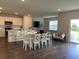 Open concept kitchen and dining area with hardwood floors at 7367 Catania Loop, Clermont, FL 34714