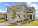 Two-story house with neutral siding and a two-car garage at 7367 Catania Loop, Clermont, FL 34714