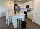 Bright kitchen features white cabinets, stainless steel appliances, and a large center island with seating at 7367 Catania Loop, Clermont, FL 34714