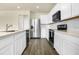Modern kitchen features white cabinets, stainless steel appliances, and beautiful countertops at 7367 Catania Loop, Clermont, FL 34714