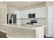 Bright kitchen with white cabinetry, stainless steel appliances, and a spacious center island at 7367 Catania Loop, Clermont, FL 34714