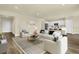 Open living room with neutral color palette and modern furnishings at 7367 Catania Loop, Clermont, FL 34714