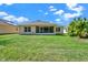 Spacious backyard with lush lawn and views of the home's screened in patio at 4223 Arlington Ridge Blvd, Leesburg, FL 34748