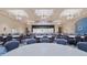Large banquet hall with tables, chairs, chandeliers, and a stage, perfect for community events at 4223 Arlington Ridge Blvd, Leesburg, FL 34748