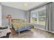 Well-lit bedroom with wide windows and a charming view of the outdoors at 4223 Arlington Ridge Blvd, Leesburg, FL 34748