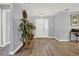 Clean and bright entryway with hardwood floors and a large plant at 4223 Arlington Ridge Blvd, Leesburg, FL 34748