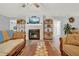 Living room with a cozy fireplace and a large TV at 4223 Arlington Ridge Blvd, Leesburg, FL 34748