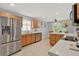 Modern kitchen with stainless steel appliances and light wood cabinets at 4223 Arlington Ridge Blvd, Leesburg, FL 34748