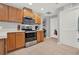 Spacious kitchen with stainless steel oven and microwave, stylish cabinets, and tiled floors at 4223 Arlington Ridge Blvd, Leesburg, FL 34748