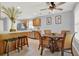 Kitchen with stainless steel appliances, center island with bar seating, and a dining area at 4223 Arlington Ridge Blvd, Leesburg, FL 34748