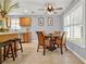Bright kitchen with stainless steel appliances, a dining area, and a stylish ceiling fan at 4223 Arlington Ridge Blvd, Leesburg, FL 34748