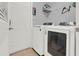Convenient laundry area equipped with modern washer and dryer, complemented by shelving for storage solutions at 4223 Arlington Ridge Blvd, Leesburg, FL 34748