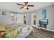 Open bedroom featuring a ceiling fan, barn door, and access to the patio at 4223 Arlington Ridge Blvd, Leesburg, FL 34748