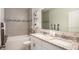 Bathroom with double vanity, a soaking tub, and shower at 704 Village Ct, Fruitland Park, FL 34731