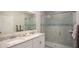 Bathroom with double vanity, a large shower, and modern fixtures at 704 Village Ct, Fruitland Park, FL 34731