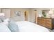 Main bedroom with en-suite bathroom and dresser at 704 Village Ct, Fruitland Park, FL 34731