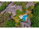 Aerial view showcasing the community layout, pool, lush greenery, and parking areas at 478 N Pin Oak Pl # 308, Longwood, FL 32779