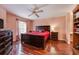 Comfortable bedroom with hardwood floors, ceiling fan, dresser, and bedside tables at 478 N Pin Oak Pl # 308, Longwood, FL 32779