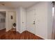 Bright entryway featuring hard wood floors, a laundry closet, and a white front door at 478 N Pin Oak Pl # 308, Longwood, FL 32779