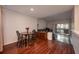 A living room with wood floors connects to a dining area and a balcony at 478 N Pin Oak Pl # 308, Longwood, FL 32779