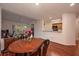 The wood floors connect the dining area, living room, and kitchen at 478 N Pin Oak Pl # 308, Longwood, FL 32779
